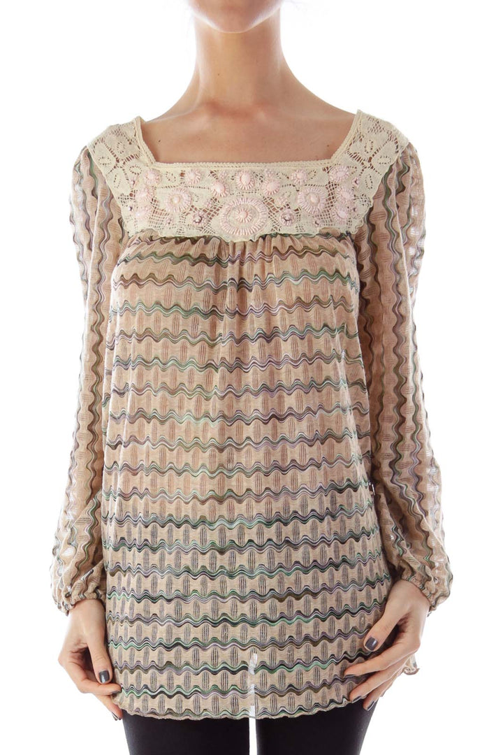 Front view of Free People beige tunic top with crochet lace and wavy pastel pattern