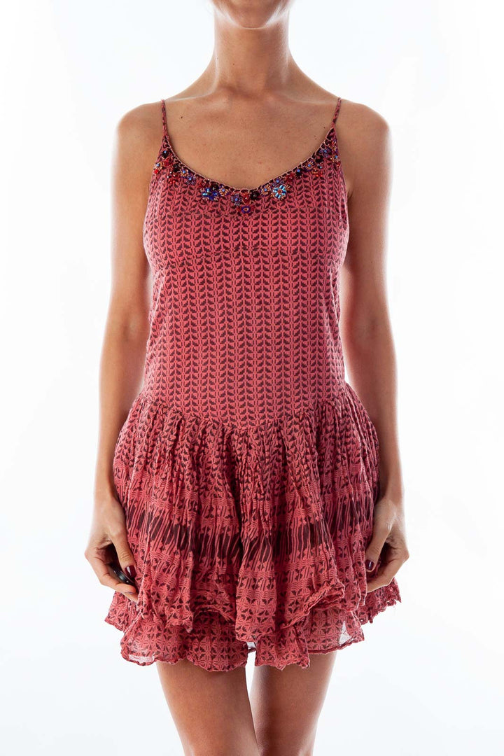 Front view of pink crochet mini dress with tiered skirt and spaghetti straps