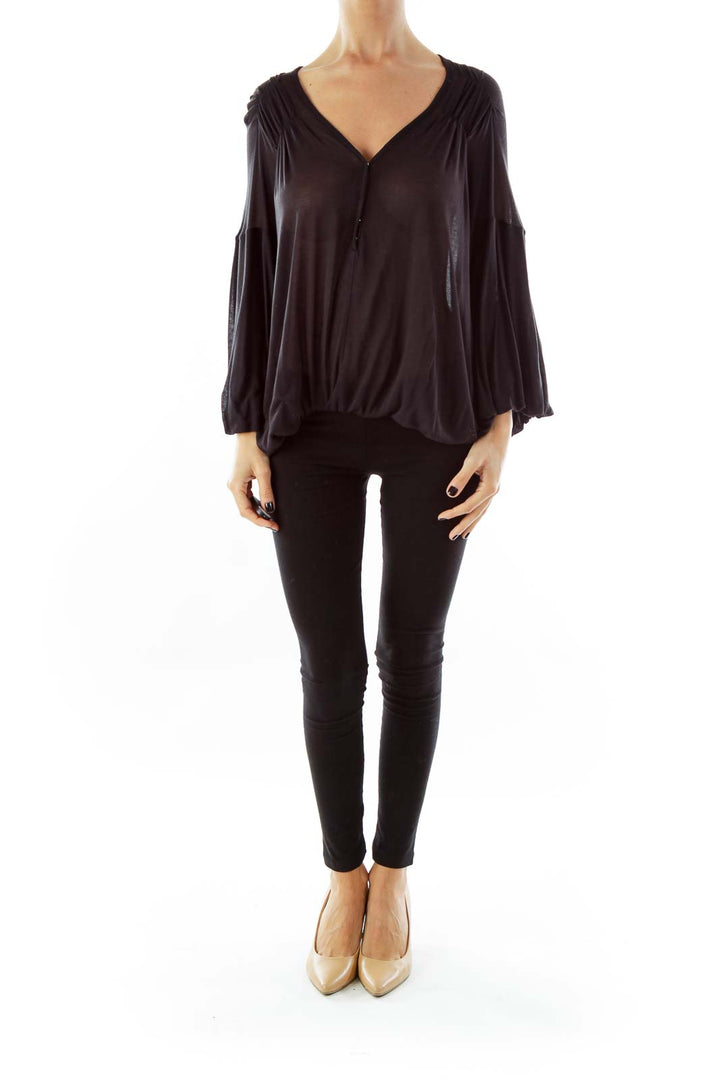 Front view of black Free People flowy top with V-neck and bell sleeves