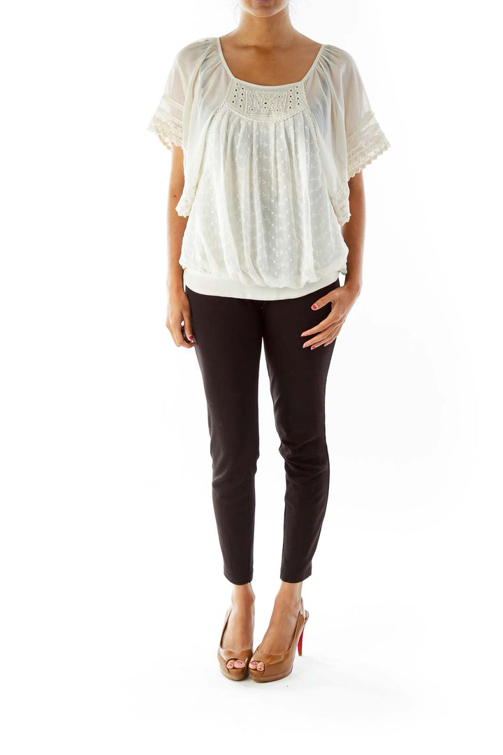 Front view of white eyelet lace peasant blouse from Free People