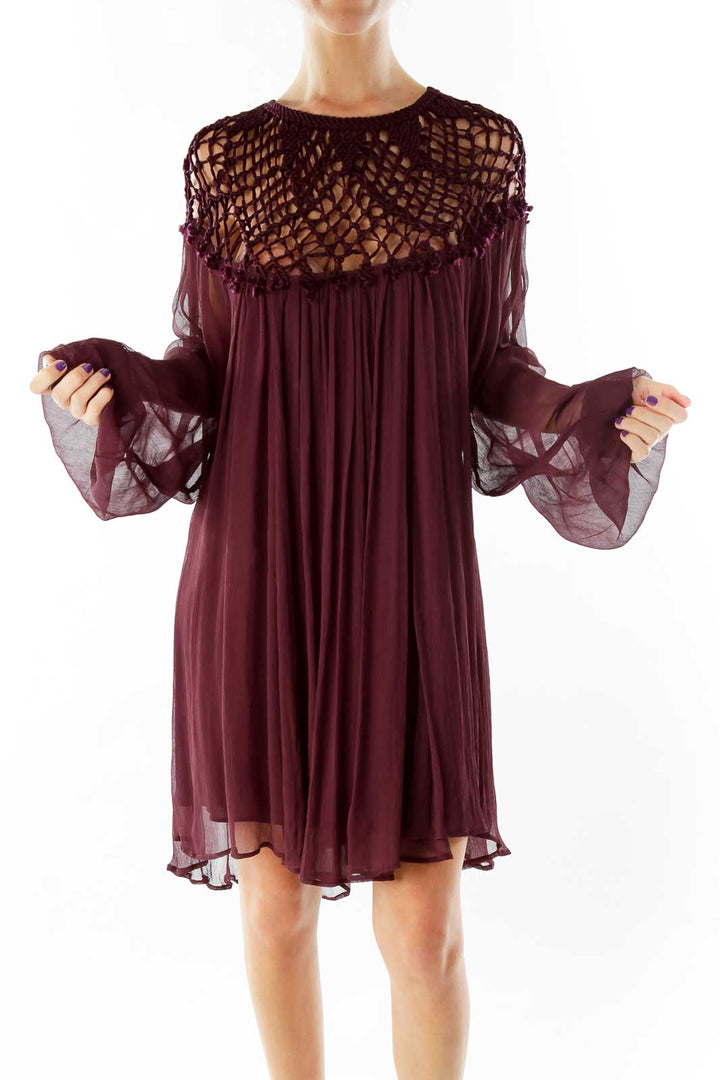 Front view of burgundy Free People dress with crochet yoke and flowy silhouette