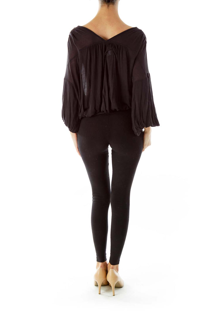 Back view of black Free People flowy top showing draped silhouette