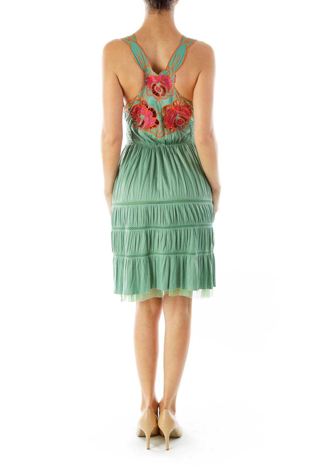 Back view of sage green sundress showcasing red floral embroidery and crossed straps