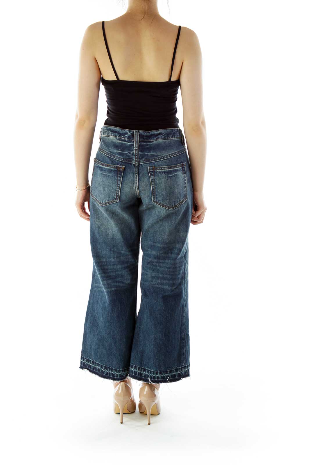 Back view of Free People blue wide-leg cropped jeans showing pocket design