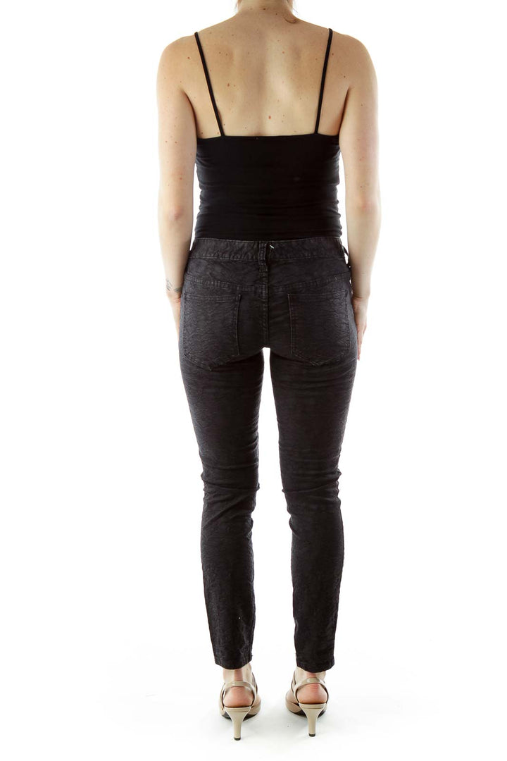 Back view of Free People black textured skinny pants on model