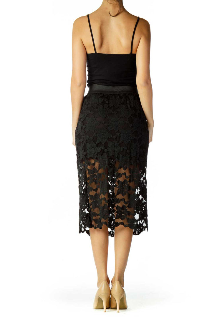 Back view of Free People black lace midi skirt showing scalloped hem