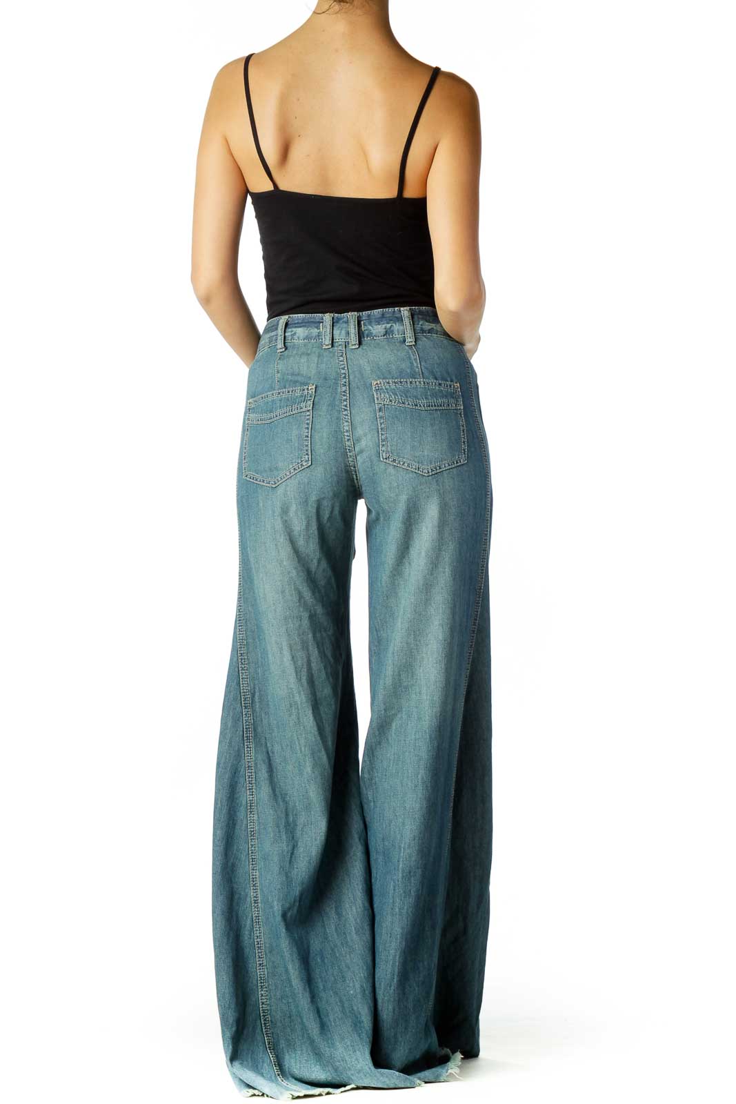 Back view of Free People light blue wide-leg denim pants showing pocket details