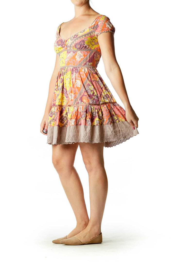 Front view of multicolor floral Free People babydoll mini dress with puff sleeves