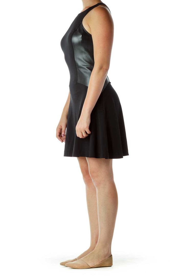 Front view of Express black fit-and-flare dress with faux leather panels