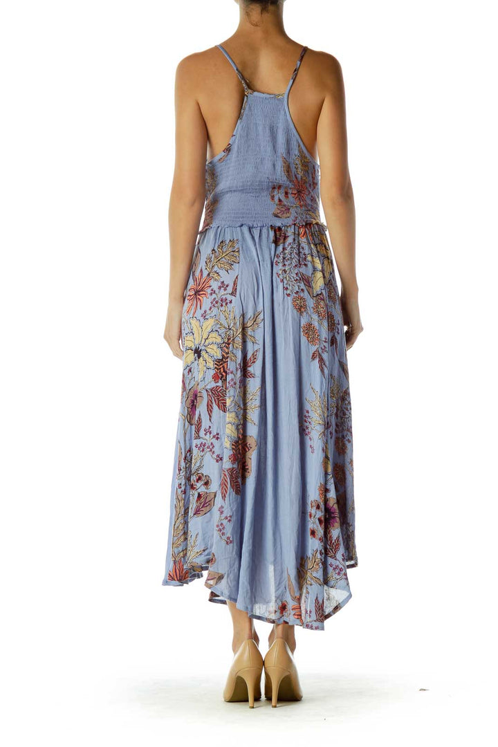 Back view of Free People blue floral maxi dress showing thin straps and flowing skirt