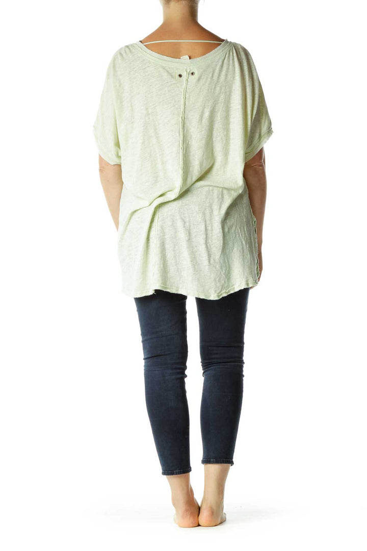 Back view of mint green oversized V-neck t-shirt from Free People showing relaxed fit