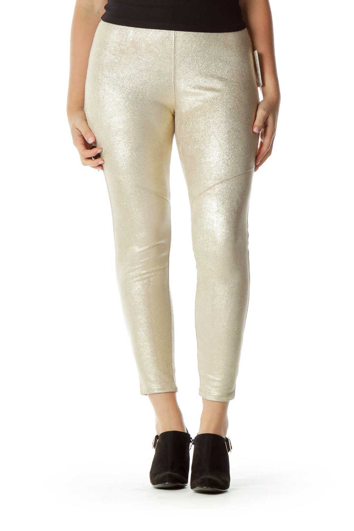 Front view of gold metallic skinny pants from Free People