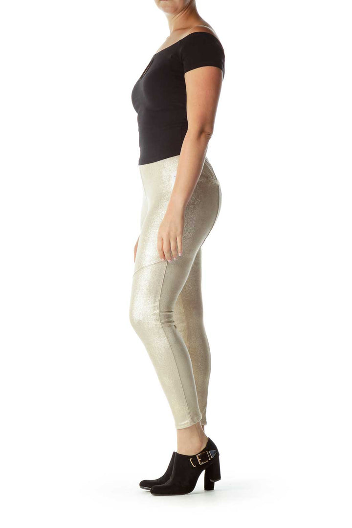 Front view of gold metallic skinny pants from Free People