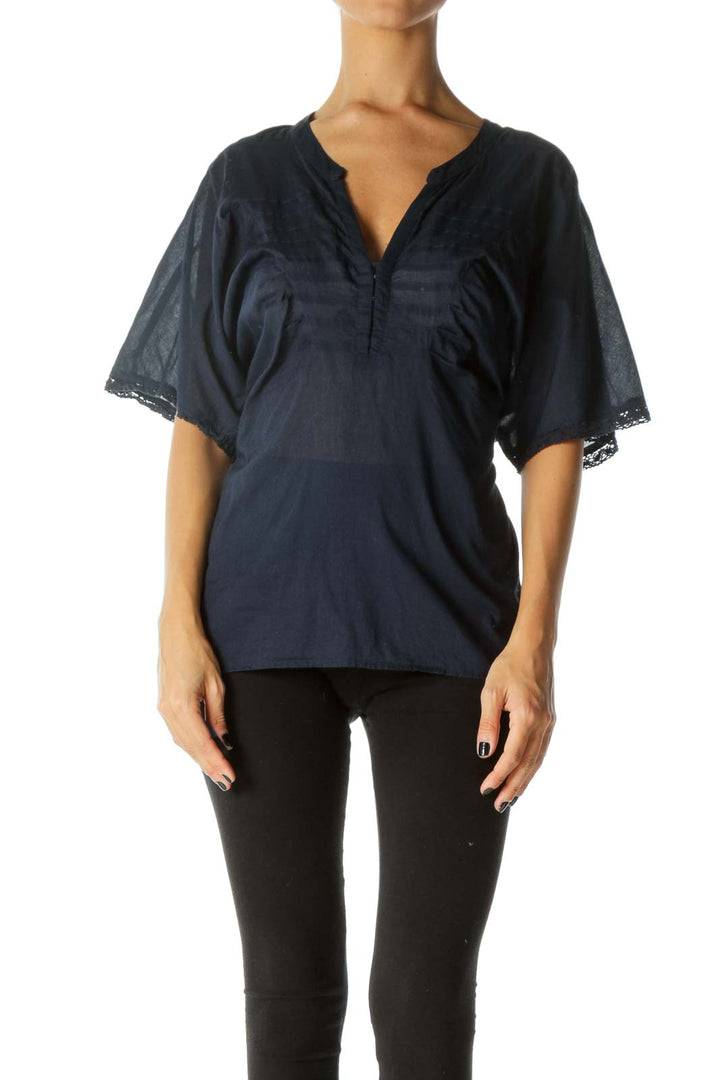 Front view of Free People navy blouse with lace-trimmed bell sleeves and V-neckline