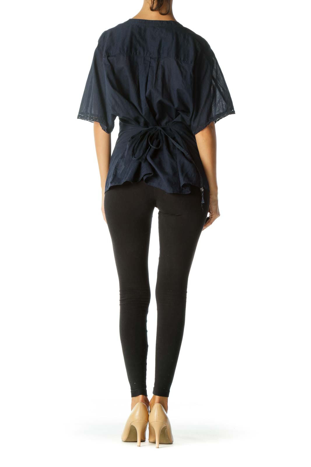 Back view of Free People navy blouse showing tie detail and flowing silhouette