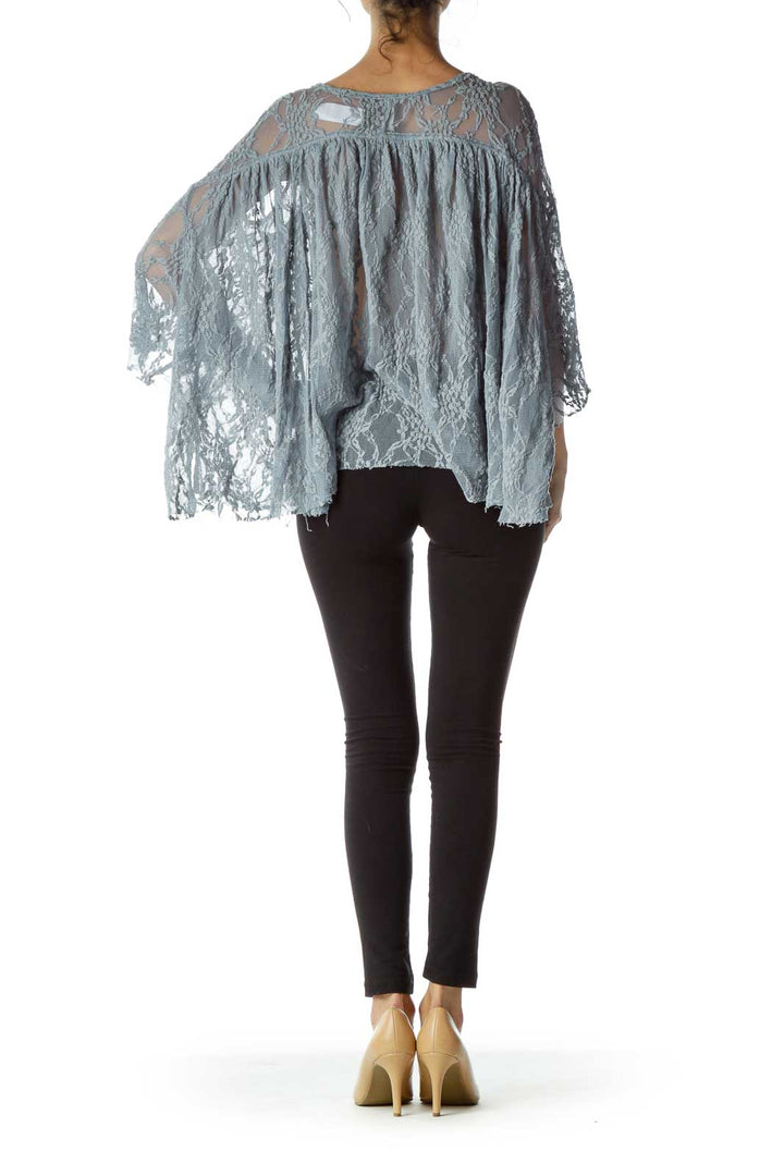 Back view of gray lace sheer poncho top showing high-low hemline