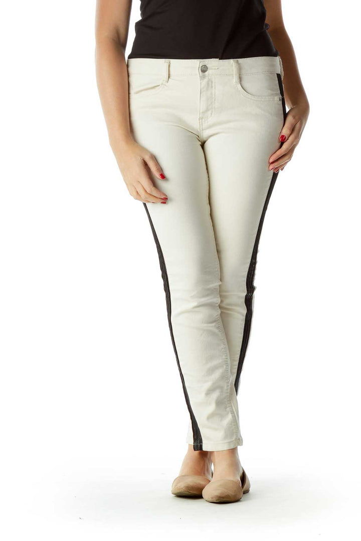 Front view of Free People white skinny pants with black side stripes