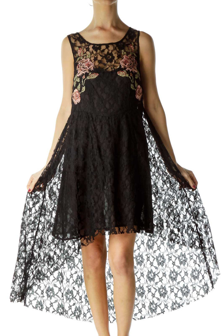 Front view of Free People black lace dress with floral embroidery and high-low hem