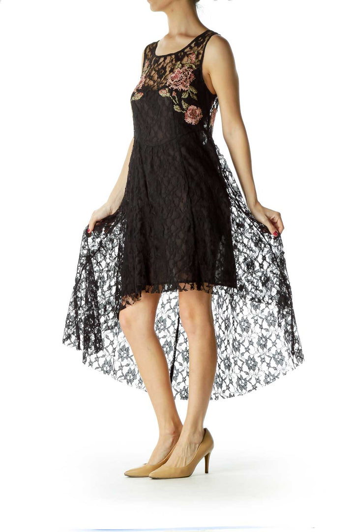 Front view of Free People black lace dress with floral embroidery and high-low hem