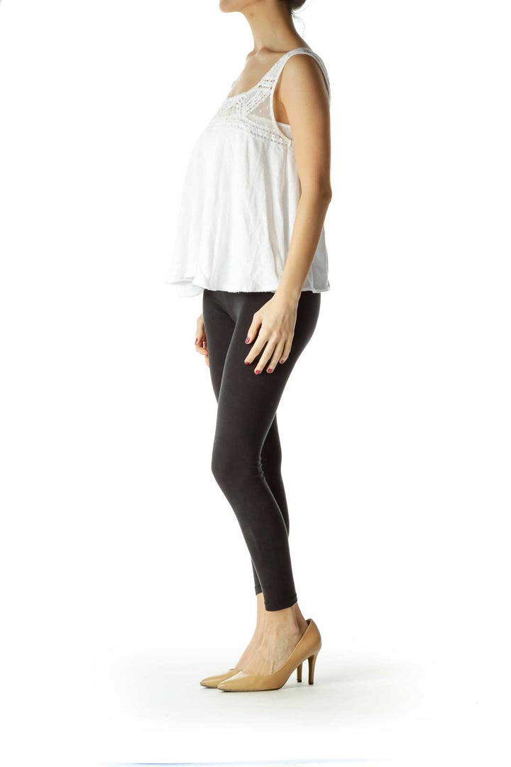 Front view of white lace-trimmed sleeveless top by Free People