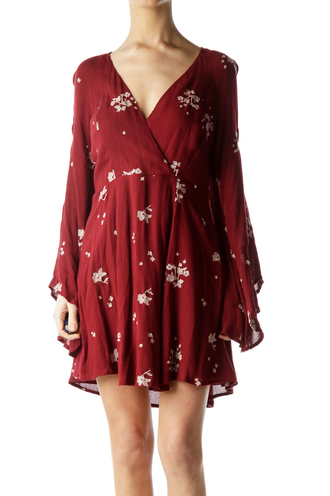 Front view of burgundy Free People mini dress with white floral print and bell sleeves