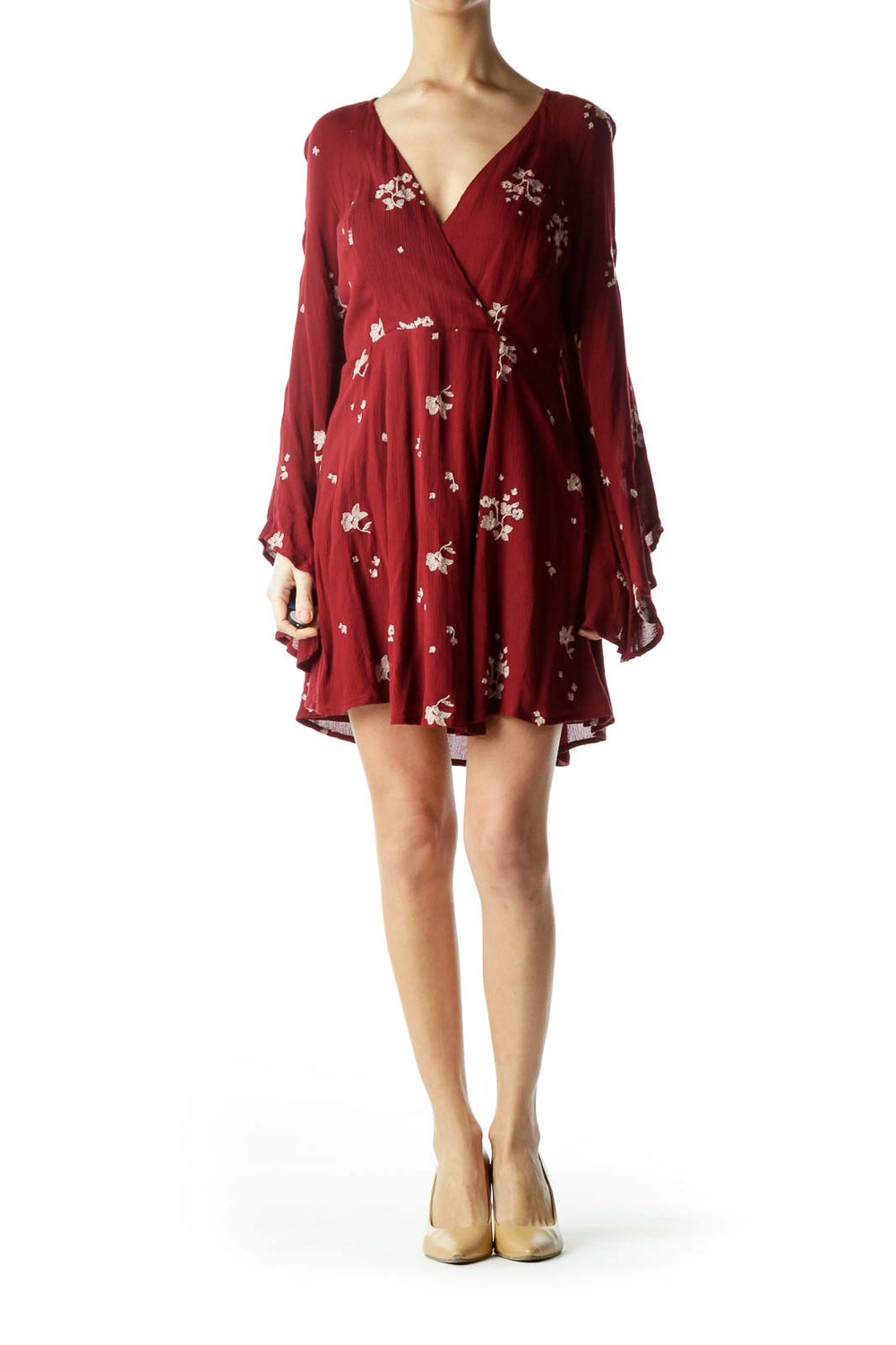 Front view of burgundy Free People mini dress with white floral print and bell sleeves