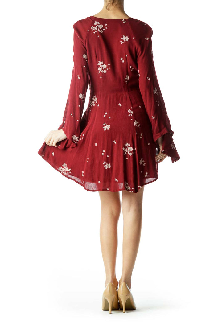 Back view of burgundy Free People mini dress showing floral print and flared skirt