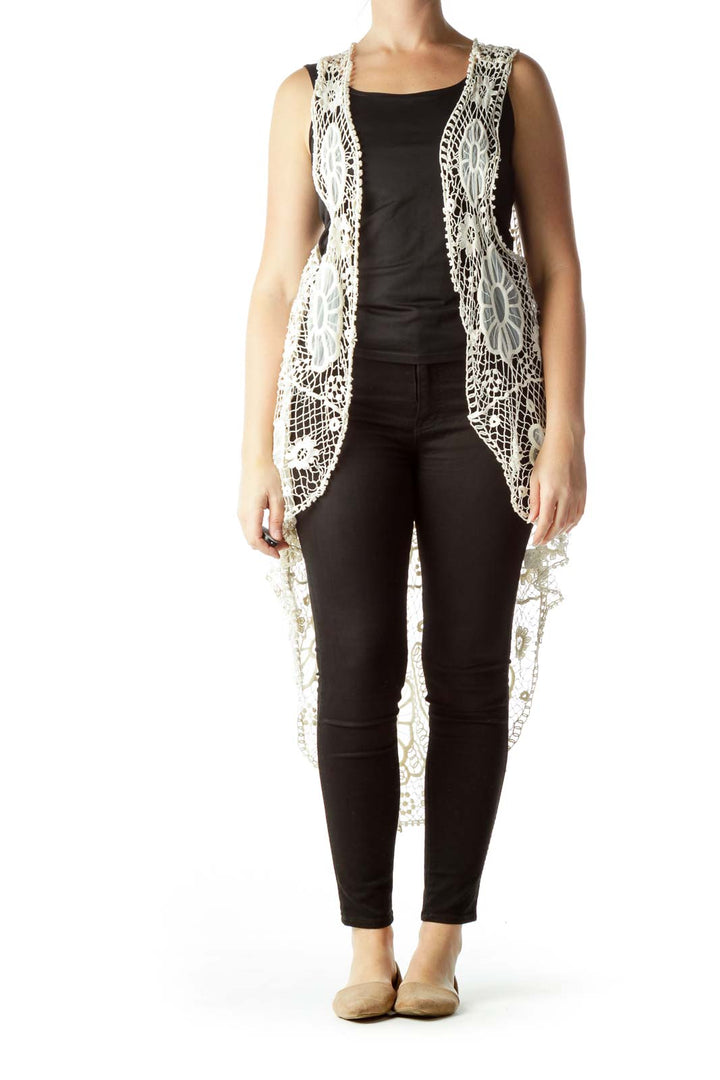 Front view of white crochet lace vest with intricate floral pattern