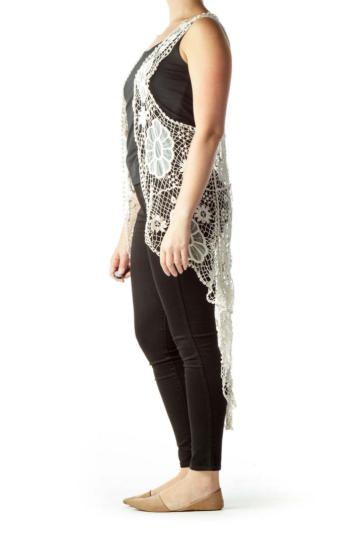 Front view of white crochet lace vest with intricate floral pattern