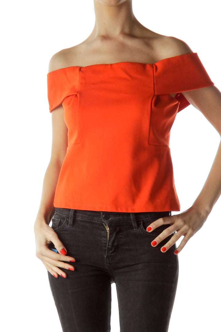 Front view of orange off-shoulder crop top by Deletta