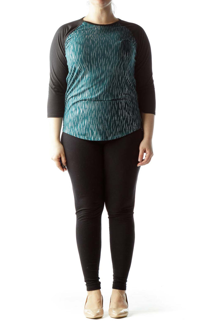 Front view of Lula Roe teal patterned raglan sleeve top with black sleeves