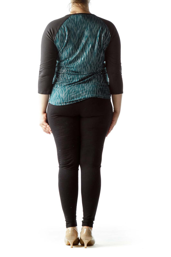 Back view of Lula Roe teal patterned raglan sleeve top showing full pattern