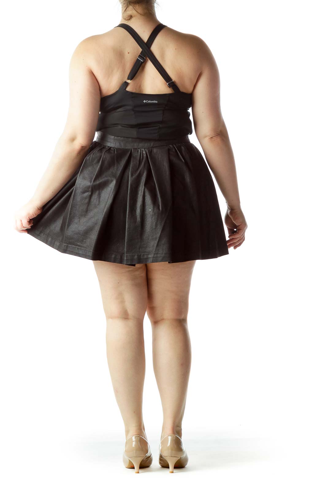 Back view of BCBGeneration black pleated mini skirt on model