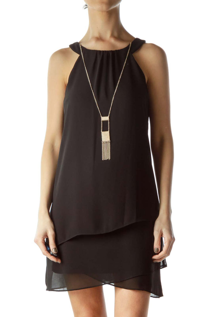 Front view of black layered chiffon cocktail dress with halter neckline