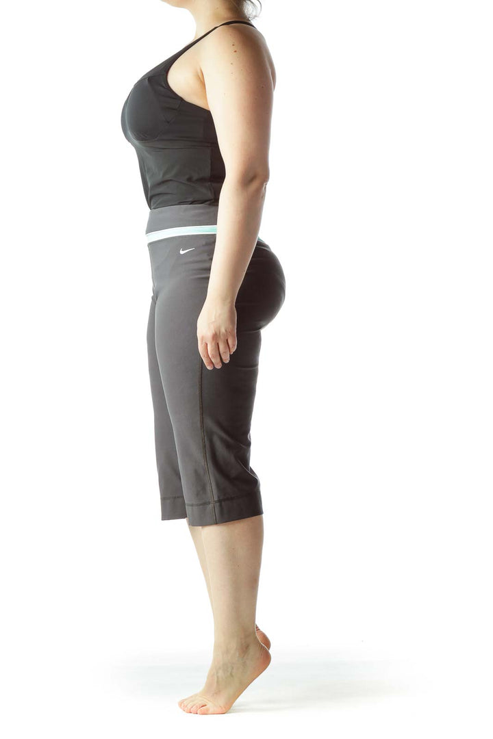 Front view of gray Nike capri yoga pants with mint waistband trim