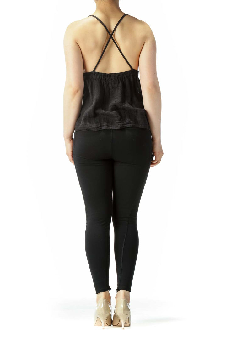 Back view of black camisole top showing cross-back straps design