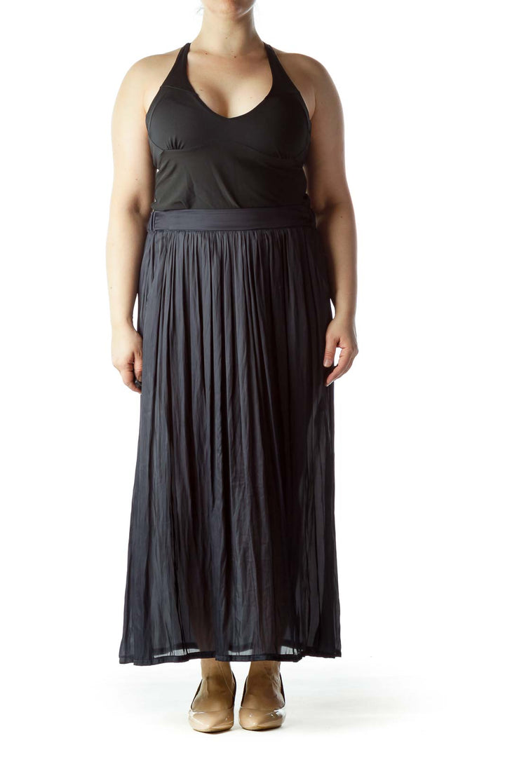 Front view of Lauren Vidal black pleated maxi skirt on model