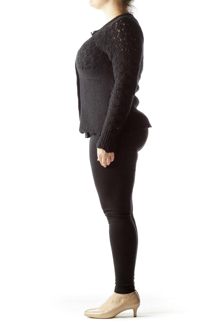 Front view of Juicy Couture black knit cardigan with lace pattern and silver buttons