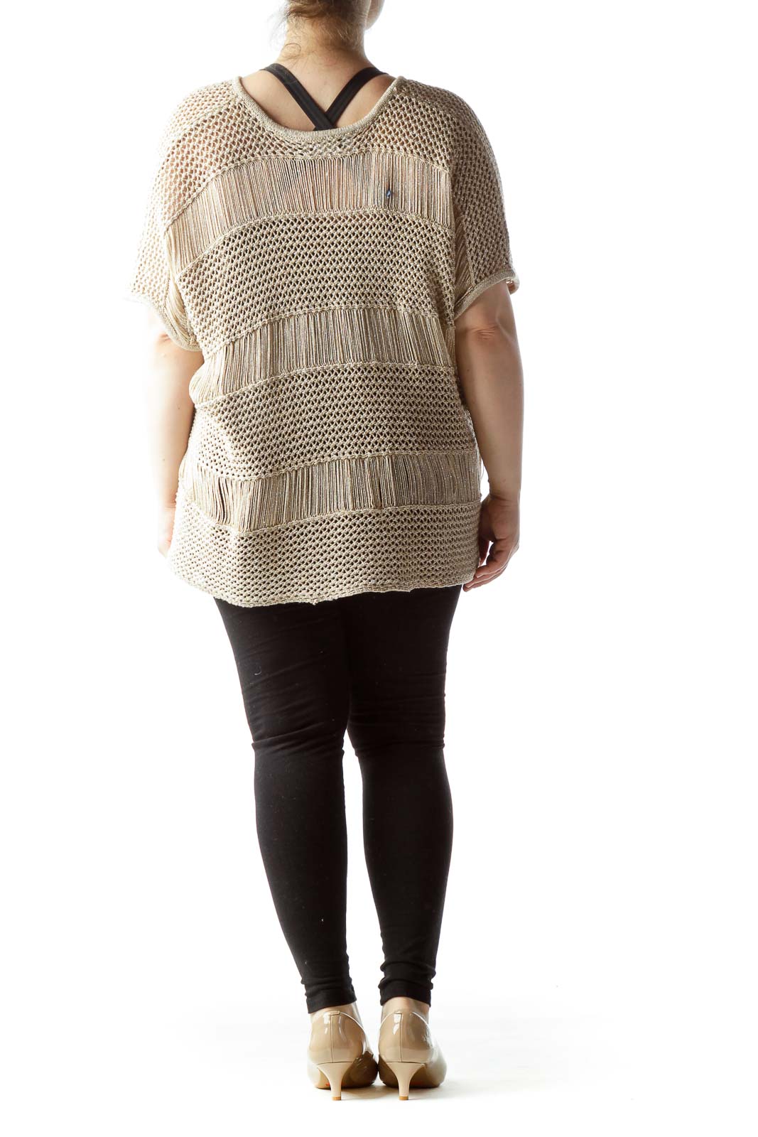 Back view of beige knitted poncho top showing fringe and knit pattern