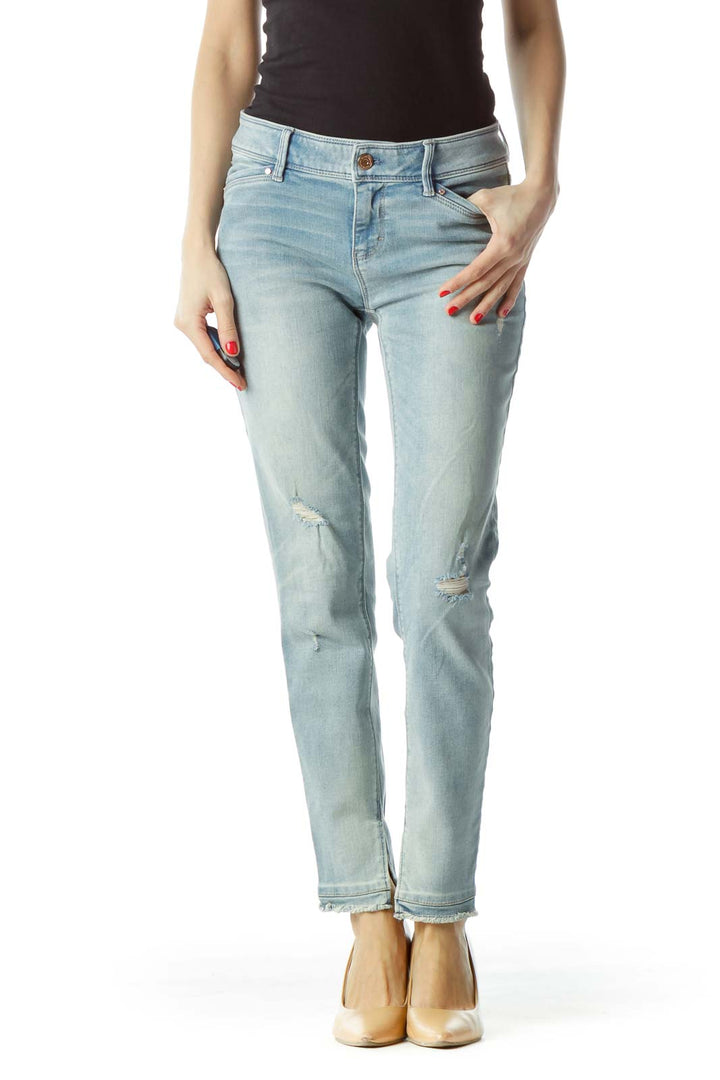 Front view of White House Black Market light blue distressed skinny jeans