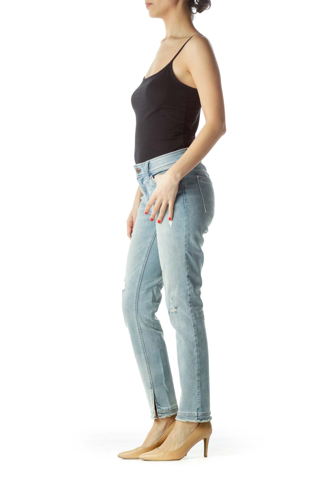 Front view of White House Black Market light blue distressed skinny jeans