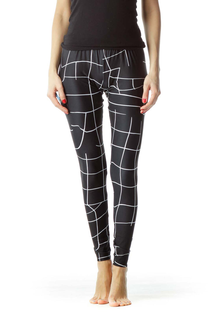 Front view of Puma black geometric print activewear leggings