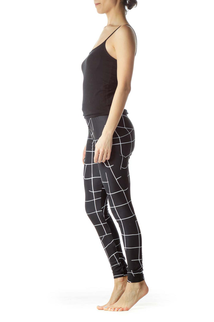 Front view of Puma black geometric print activewear leggings