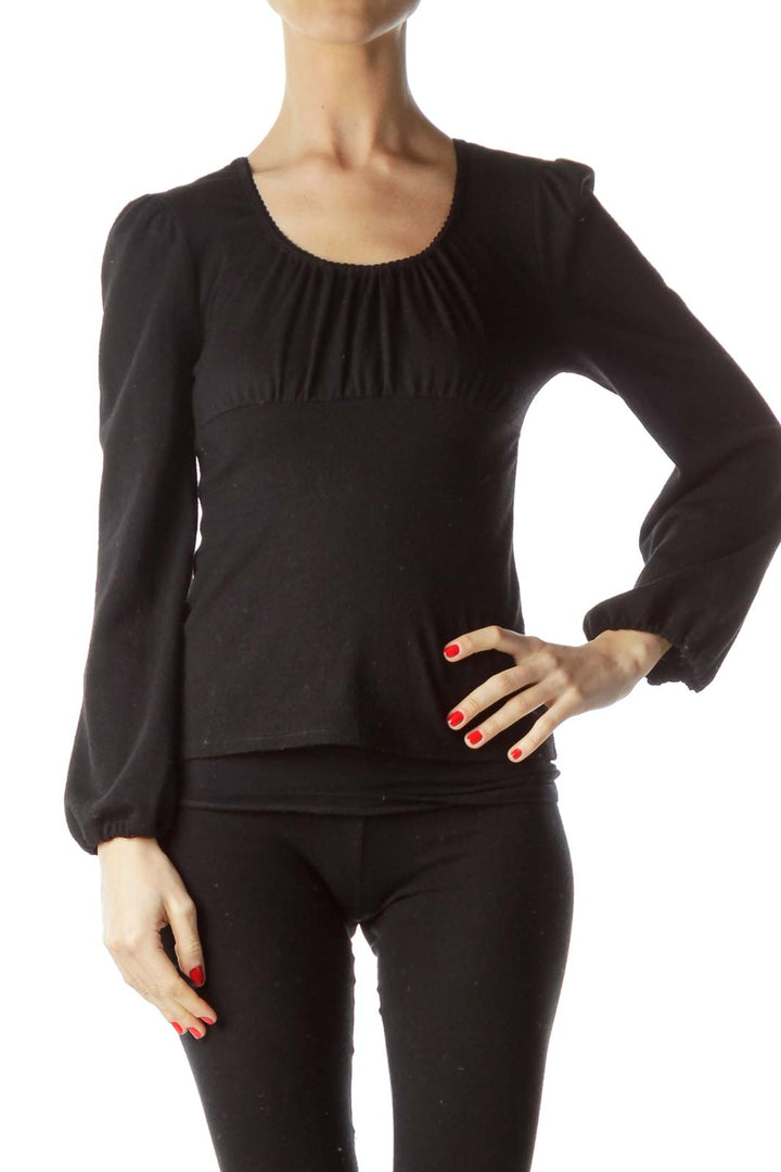 Front view of Erica Tanov black long-sleeve knit top with gathered scoop neckline