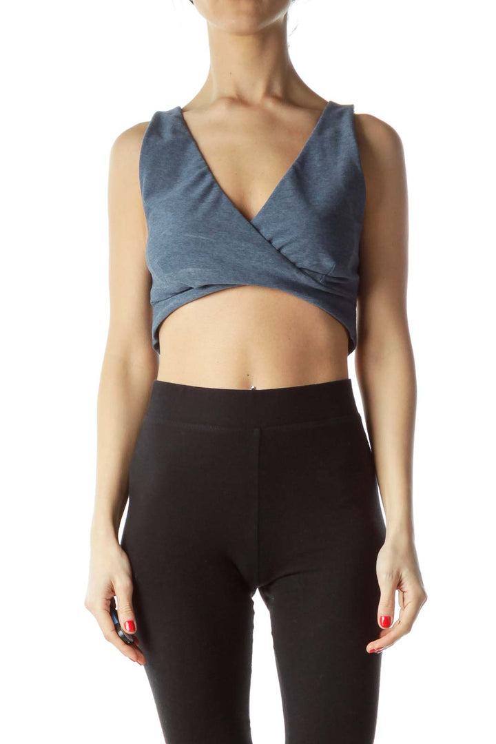 Front view of blue JoyLab wrap-style crop top on model