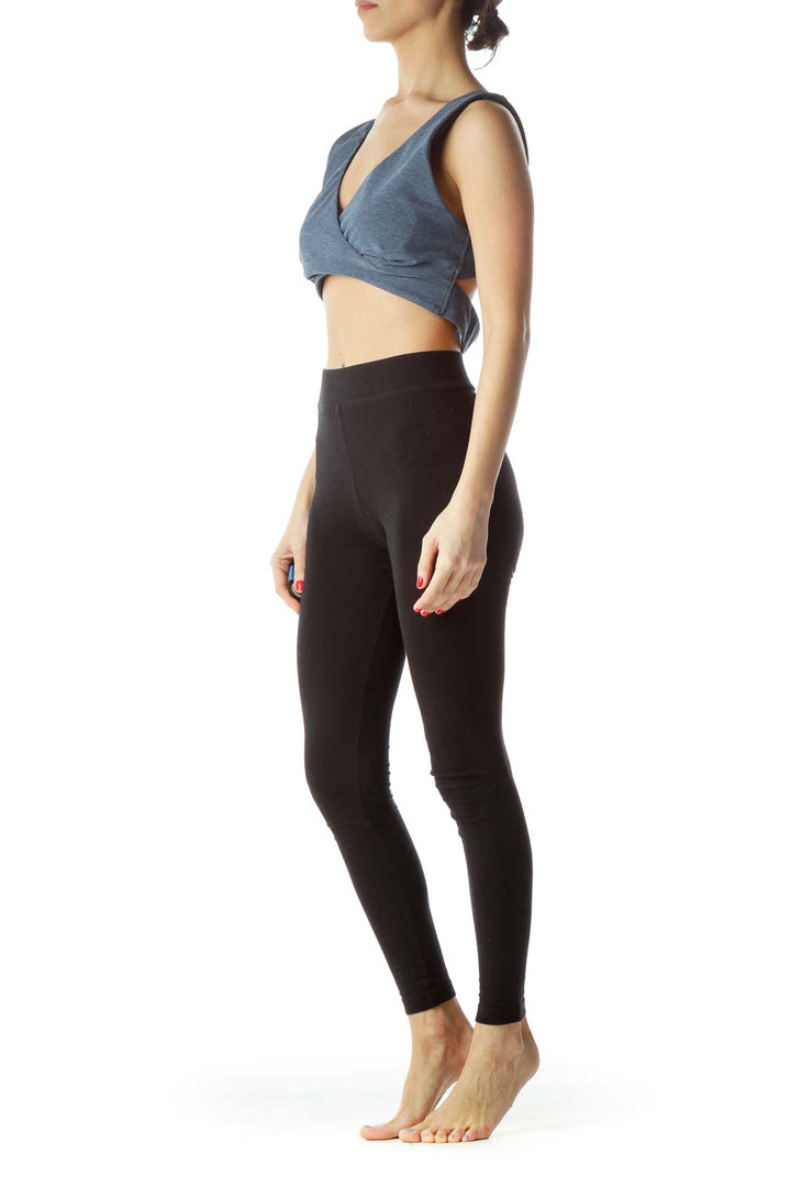 Front view of blue JoyLab wrap-style crop top on model