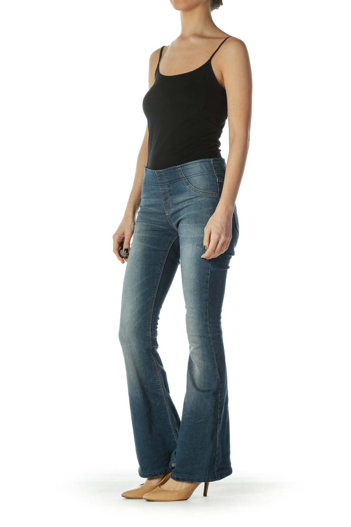 Front view of Free People blue flared denim jeans on model