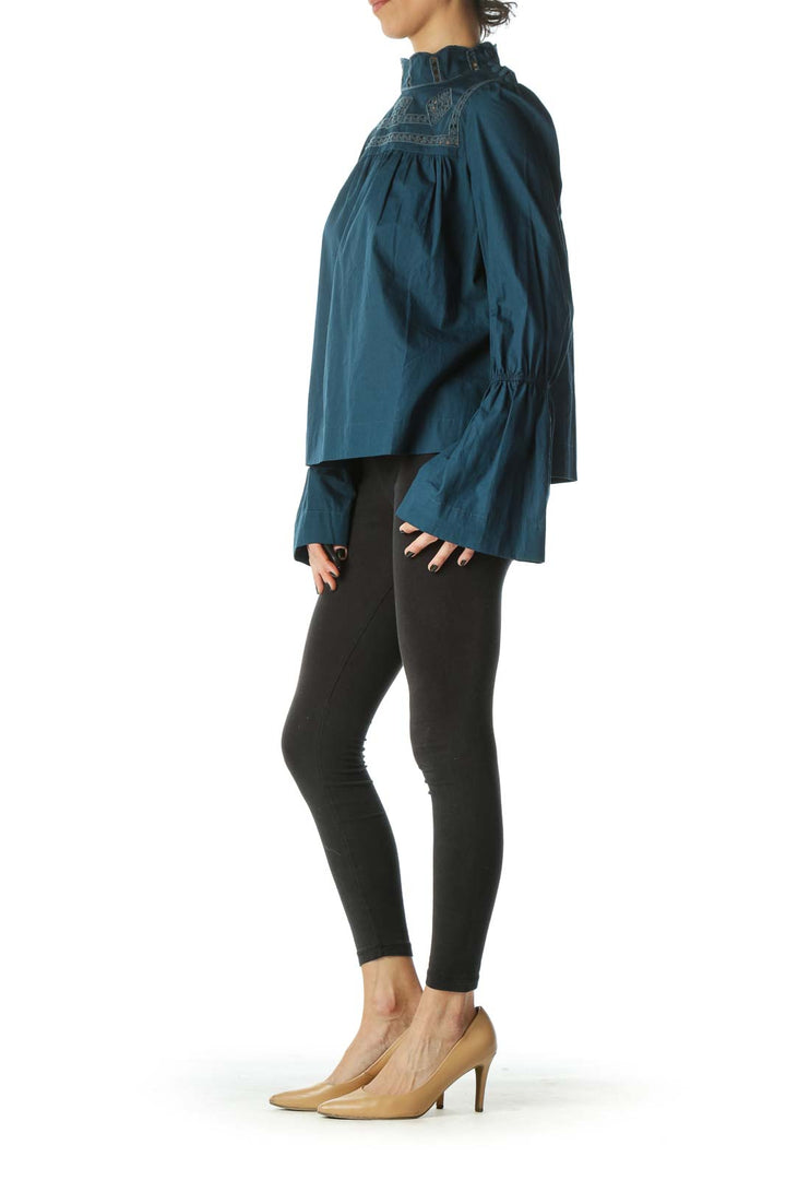 Front view of teal Free People blouse with embroidered neckline and bell sleeves