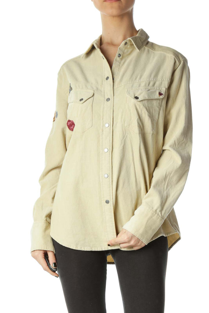 Front view of Free People beige embroidered button-up jacket on model