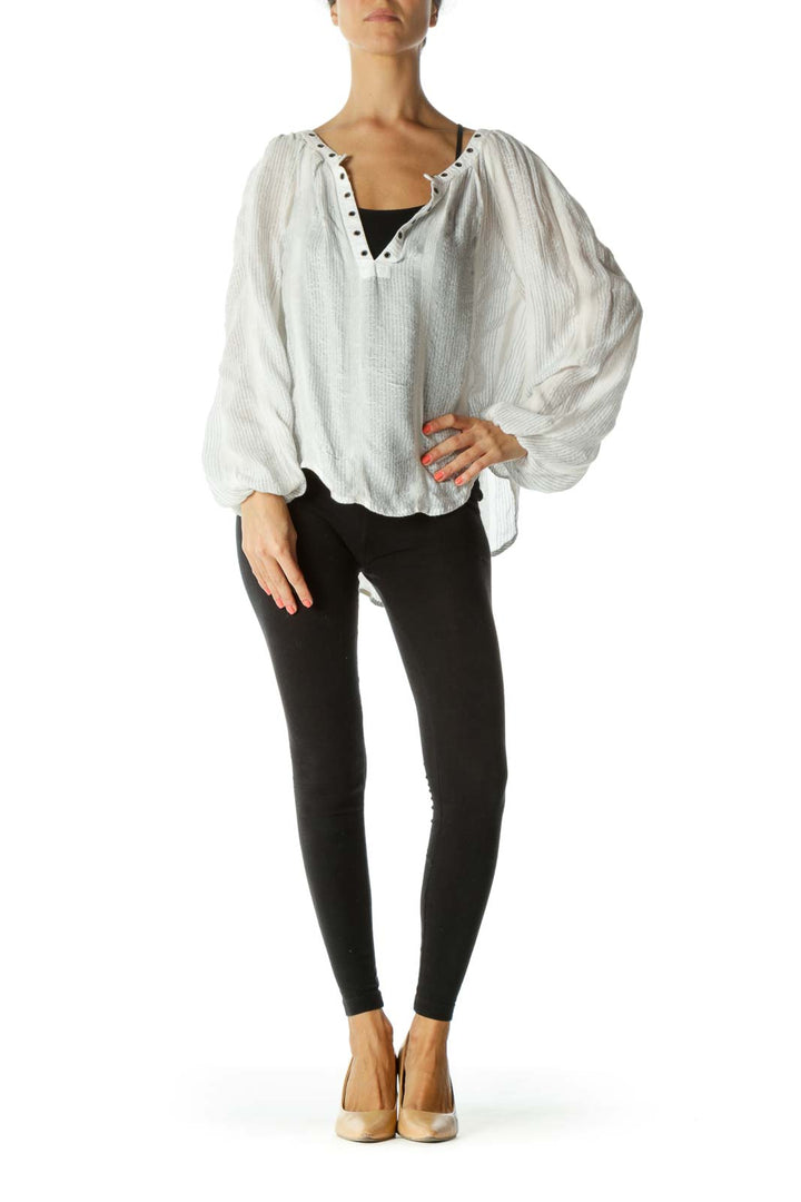 Front view of white Free People blouse with billowing sleeves and stud-detailed V-neckline